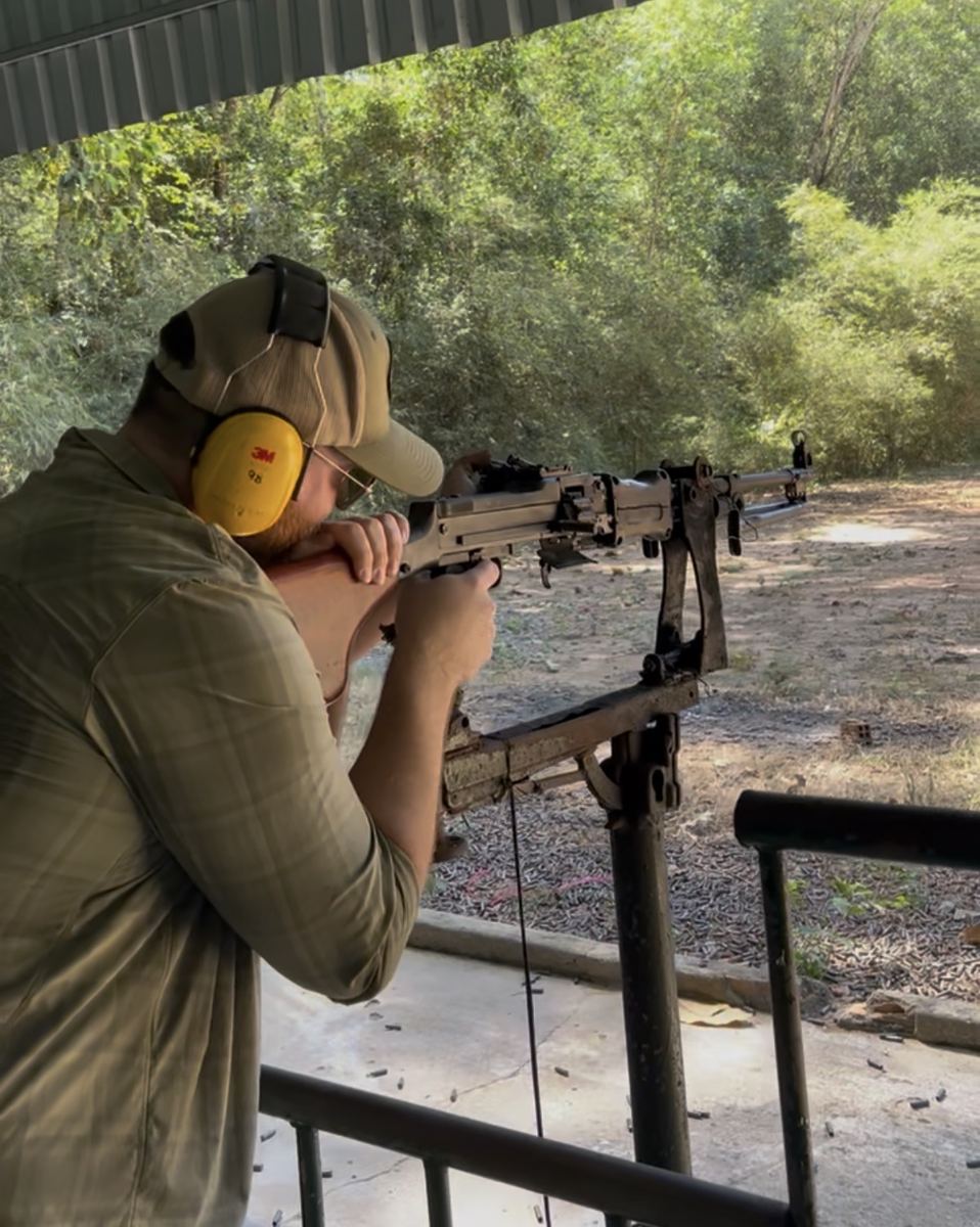 John firing a machine gun at the Cu Chi Tunnels shooting range