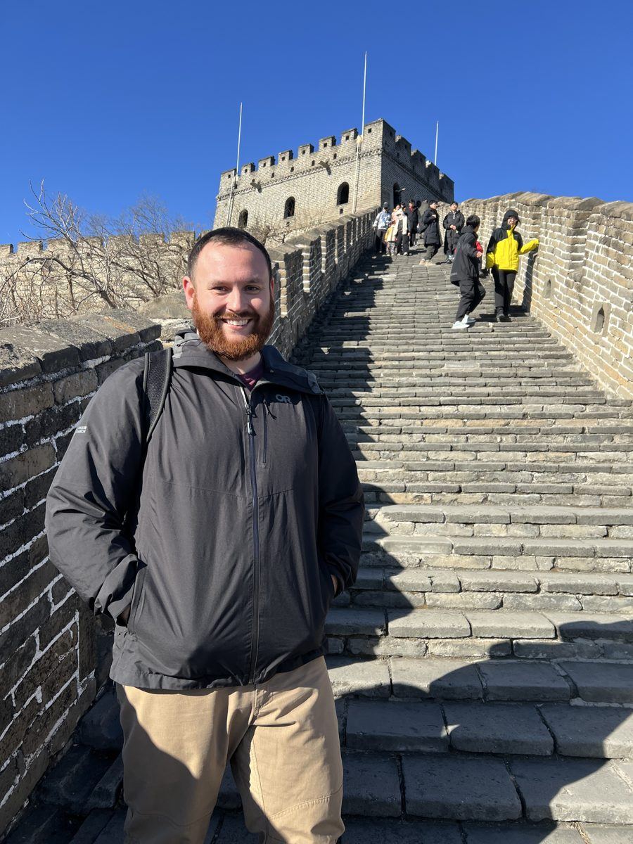 John on the stone steps below a watchtower at Mutianyu